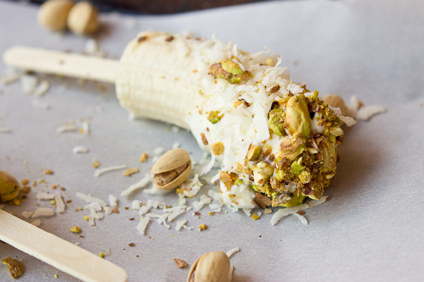  These Banana Crunch Pops are just what you need on a hot summer day, kids and adults rejoice! Only 4 ingredients and very simple to make! Place banana on stick, dunk in Greek yogurt and roll in pistachios and shredded coconut and freeze.