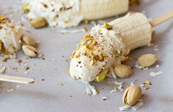  These Banana Crunch Pops are just what you need on a hot summer day, kids and adults rejoice! Only 4 ingredients and very simple to make! Place banana on stick, dunk in Greek yogurt and roll in pistachios and shredded coconut and freeze.