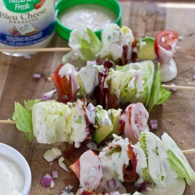 Wedge Salad Skewers…. Iceberg lettuce, crispy bacon, avocado, tomatoes, and blue cheese dressing on a stick. YUM!! This appetizer is perfect at a cookout or anytime you’re serving a crowd.