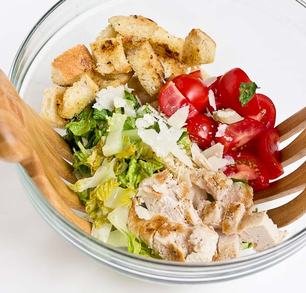 If you love chopped meal salads this Grilled Greens Chicken Caesar Chopped Salad is for you! A healthy caesar salad made with grilled romaine, grilled chicken breast, sweet tomatoes, homemade croutons, and zesty Greek yogurt caesar dressing