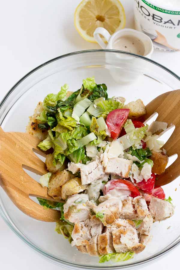If you love chopped meal salads this Grilled Greens Chicken Caesar Chopped Salad is for you! A healthy caesar salad made with grilled romaine, grilled chicken breast, sweet tomatoes, homemade croutons, and zesty Greek yogurt caesar dressing