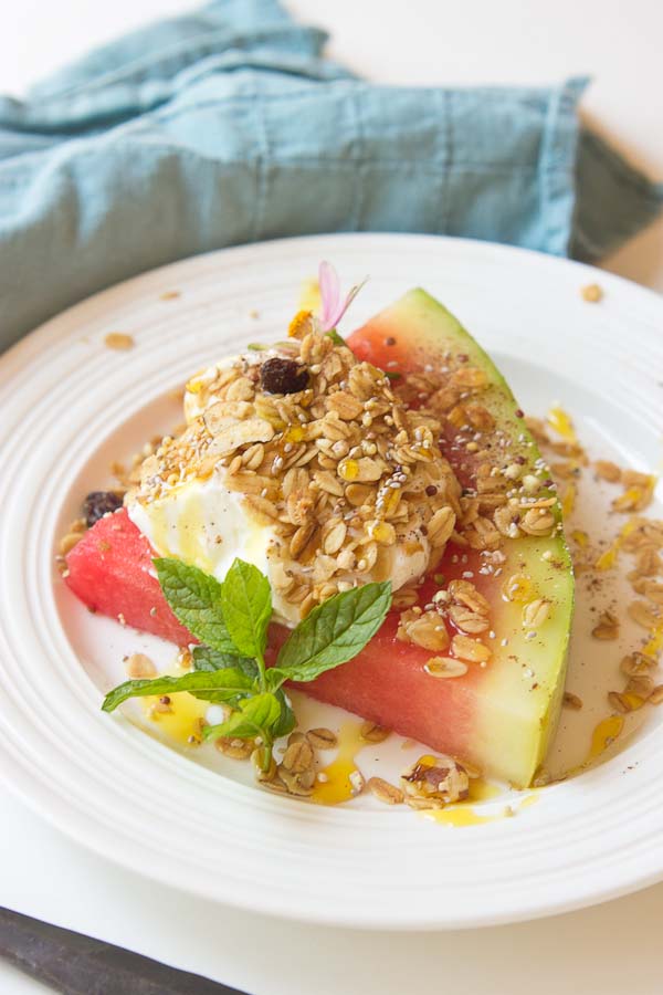 This Watermelon Breakfast Pizza is so it guys! Slice of watermelon, topped with Greek yogurt, seeds, and a drizzle of honey. Make it your own by adding your favorite toppings. The possibilities are endless. 