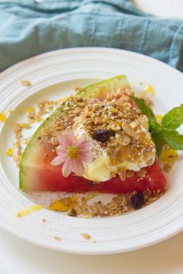 This Watermelon Breakfast Pizza is so it guys! Slice of watermelon, topped with Greek yogurt, seeds, and a drizzle of honey. Make it your own by adding your favorite toppings. The possibilities are endless.