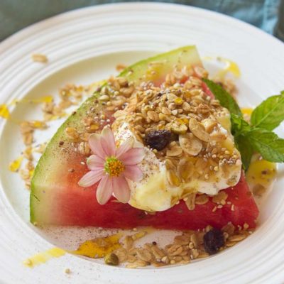 This Watermelon Breakfast Pizza is so it guys! Slice of watermelon, topped with Greek yogurt, seeds, and a drizzle of honey. Make it your own by adding your favorite toppings. The possibilities are endless.