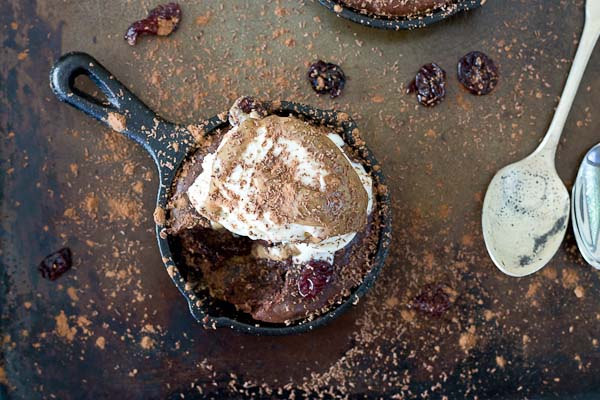 Double Chocolate Cherry Skillet Brownies a la mode with vanilla ice cream, almond butter drizzle, and chocolate shavings. This skillet brownie is lower in sugar and made with healthier ingredients like almond butter, whole grains, dried Montmorency tart cherries, and dark chocolate. 