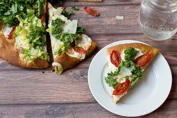 Get your Kale Caesar Salad Pizza on!! This pizza will be the talk of the town, a delicious Pizza blanca with roasted tomatoes, garlic and fresh mozzarella topped with loads of Kale Caesar Salad. 