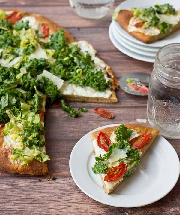 Get your Kale Caesar Salad Pizza on!! This pizza will be the talk of the town, a delicious Pizza blanca with roasted tomatoes, garlic and fresh mozzarella topped with loads of Kale Caesar Salad. 