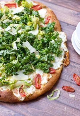 Get your Kale Caesar Salad Pizza on!! This pizza will be the talk of the town, a delicious Pizza blanca with roasted tomatoes, garlic and fresh mozzarella topped with loads of Kale Caesar Salad.