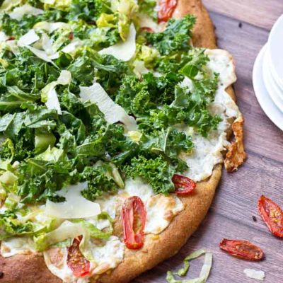 Get your Kale Caesar Salad Pizza on!! This pizza will be the talk of the town, a delicious Pizza blanca with roasted tomatoes, garlic and fresh mozzarella topped with loads of Kale Caesar Salad.