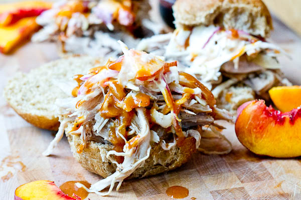 Root Beer Pulled Pork with Peach Slaw made in the slow cooker just in time for game day! This recipe has a simple ingredient list and that Homemade BBQ Sauce and those peaches in that Peach Slaw, you can't miss out on that sweetness. YUM!