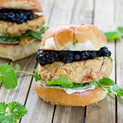 These Salmon Sliders with Blueberry Compote are quite possibly the best way to eat salmon at home! Convenience, price, and deliciousness! Warm salmon cakes, wild blueberries compote, maple goat cheese spread, toasted buttery buns = BEST FOOD EVER.