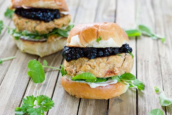 These Salmon Sliders with Blueberry Compote are quite possibly the best way to eat salmon at home! Convenience, price, and deliciousness! Warm salmon cakes, wild blueberries compote, maple goat cheese spread, toasted buttery buns = BEST FOOD EVER.