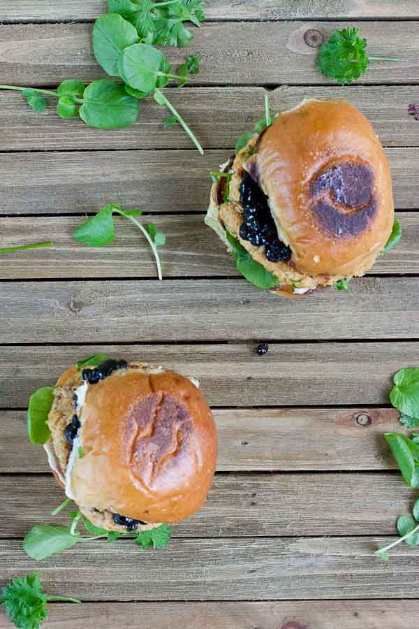 These Salmon Sliders with Blueberry Compote are quite possibly the best way to eat salmon at home! Convenience, price, and deliciousness! Warm salmon cakes, wild blueberries compote, maple goat cheese spread, toasted buttery buns = BEST FOOD EVER.