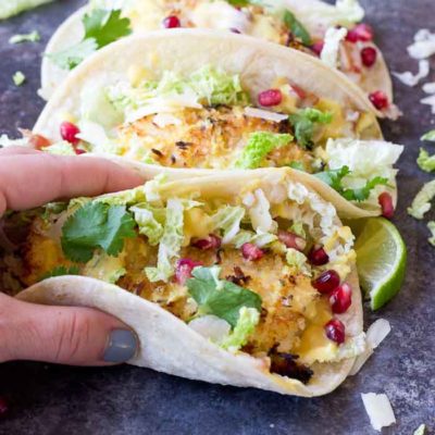 Crazy for tacos? Add these Crispy Fish Tacos to your menu! Crispy baked cod topped with pomegranates, shredded pear, and Honey Lime Crema. Simple to make at home!