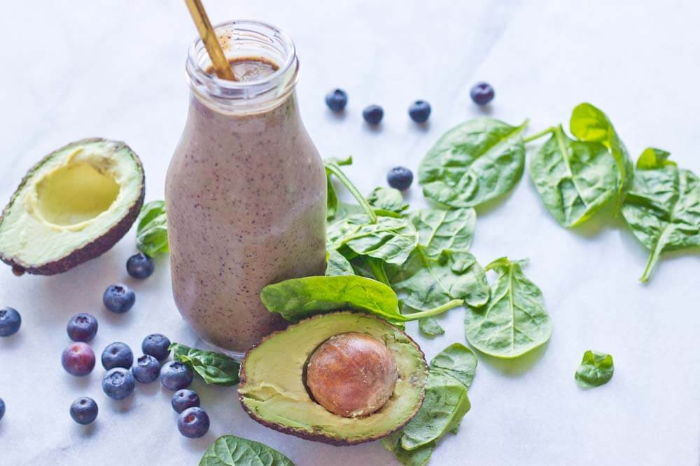This Tropical Superfood Smoothie is so energizing! A blend of fresh spinach, blueberries, avocado, banana, and pineapple in one glass! 