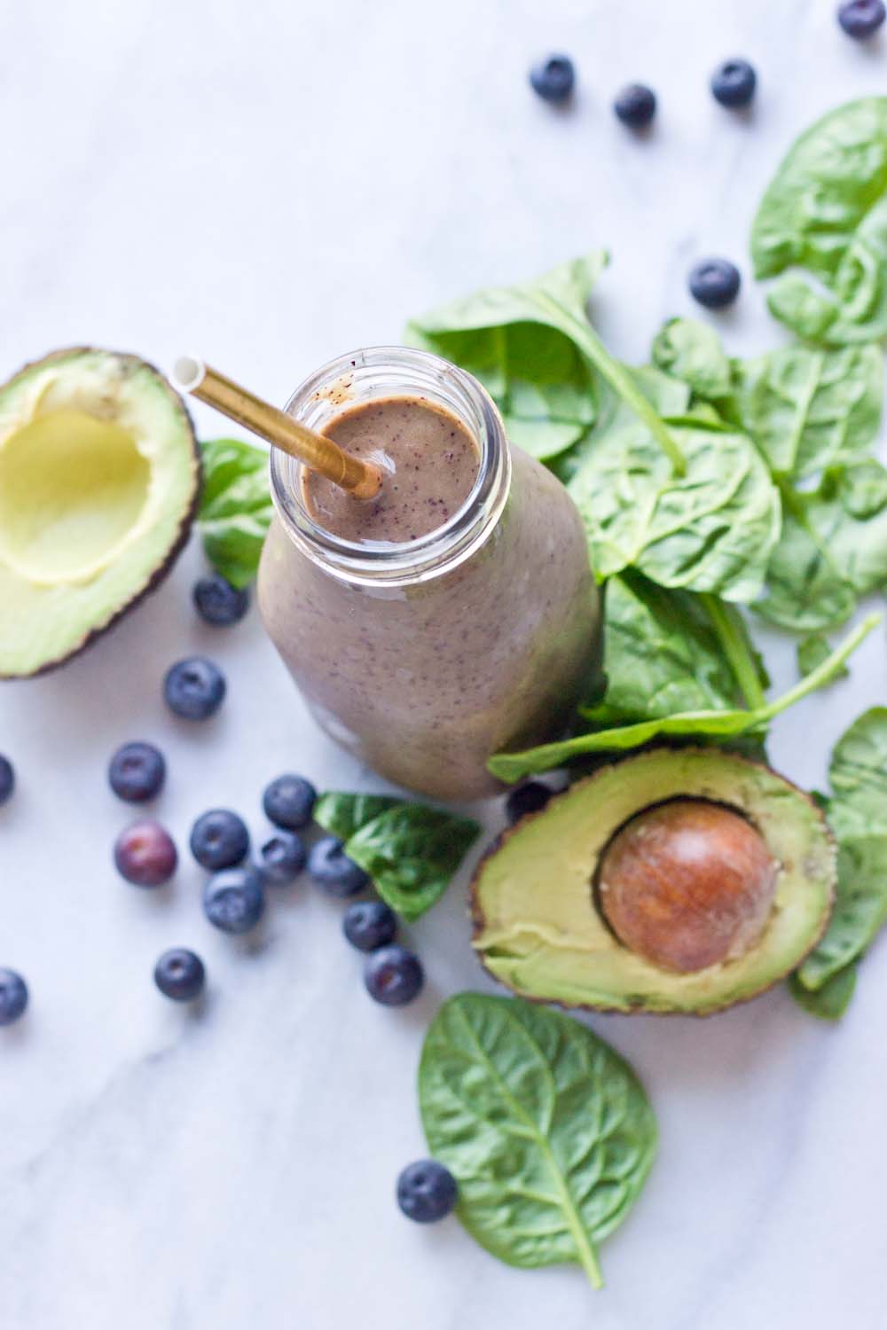 This Tropical Superfood Smoothie is so energizing! A blend of fresh spinach, blueberries, avocado, banana, and pineapple in one glass! 