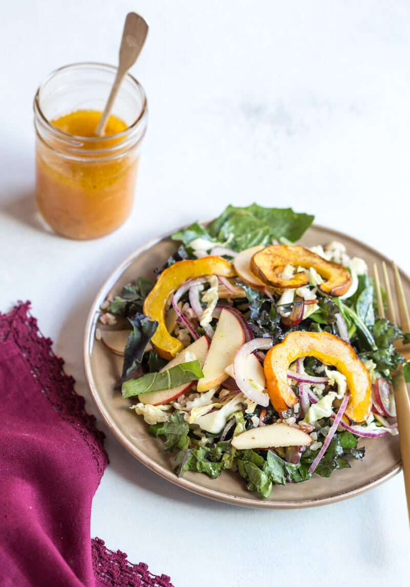 This Winter Greens Salad with Citrus Vinaigrette tho. It's exactly what should be on your holiday table--- warm acorn squash, apple slaw, winter greens, hearty grains and a tangy citrus vinaigrette! Add grilled chicken or garbanzo beans to make this salad a meal, or serve as a salad in your holiday spread.
