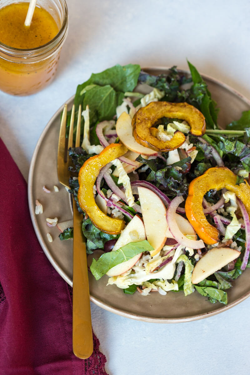 This Winter Greens Salad with Citrus Vinaigrette tho. It's exactly what should be on your holiday table--- warm acorn squash, apple slaw, winter greens, hearty grains and a tangy citrus vinaigrette! Add grilled chicken or garbanzo beans to make this salad a meal, or serve as a salad in your holiday spread.