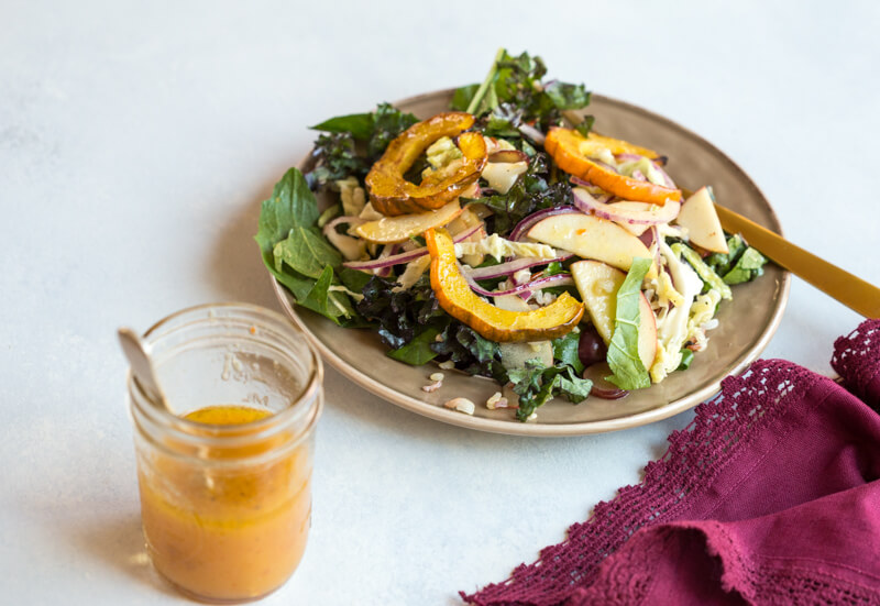 This Winter Greens Salad with Citrus Vinaigrette tho. It's exactly what should be on your holiday table--- warm acorn squash, apple slaw, winter greens, hearty grains and a tangy citrus vinaigrette! Add grilled chicken or garbanzo beans to make this salad a meal, or serve as a salad in your holiday spread.