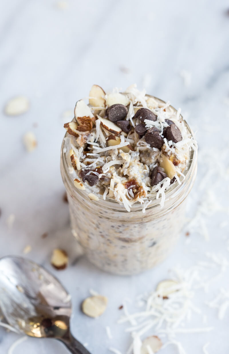 Almond Joy Overnight Oats made with coconut water.... say what??!! Yep, healthy dessert for breakfast... NO ADDED SUGAR and dairy free (well, minus the chocolate on top...but gimmeee all dat chocolate!)