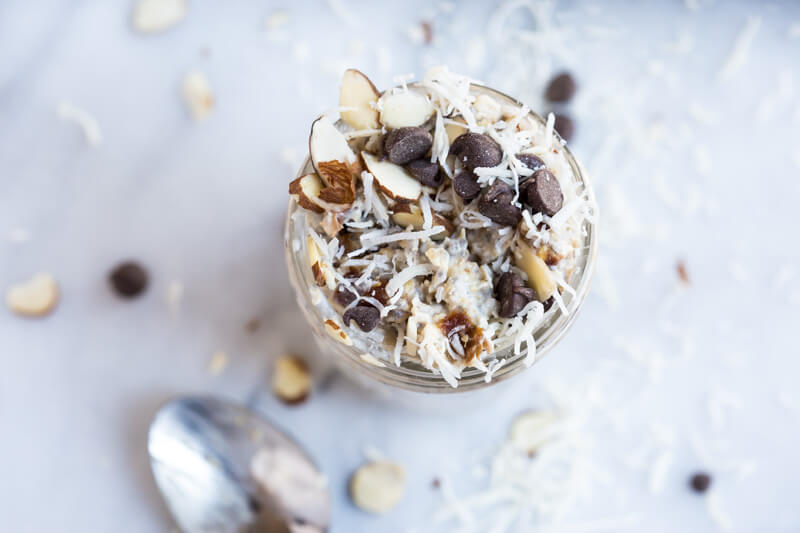 Almond Joy Overnight Oats made with coconut water.... say what??!! Yep, healthy dessert for breakfast... NO ADDED SUGAR and dairy free (well, minus the chocolate on top...but gimmeee all dat chocolate!)