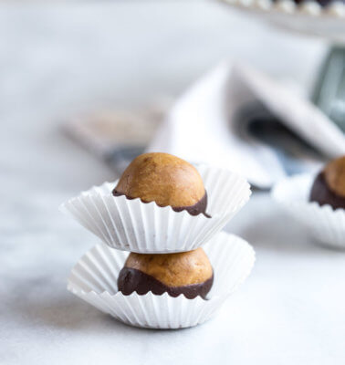 Healthy Peanut Butter Buckeyes my friends. This snack is high in protein and made with peanut butter (duh), peanut butter powder, a touch of maple syrup and dipped in dark chocolate!