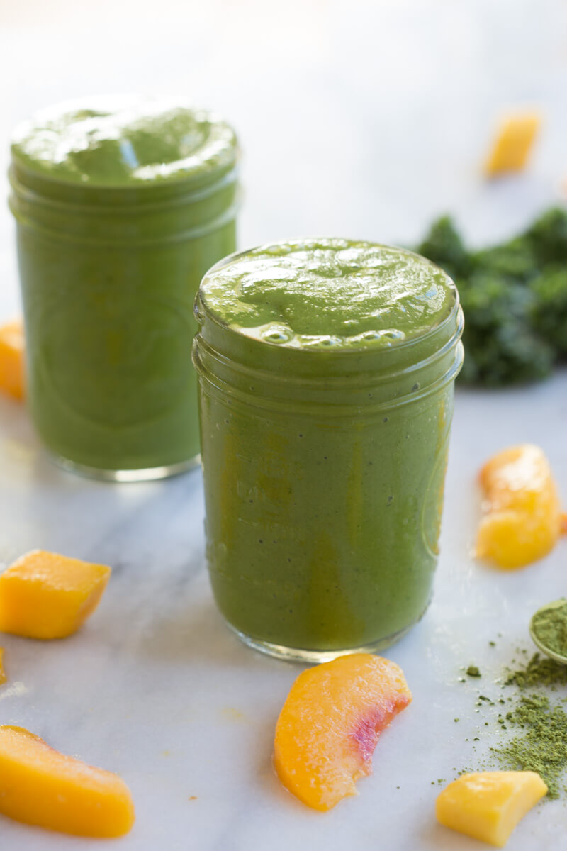 Go green with this mighty Matcha Green Tea Smoothie made with frozen mango, peaches, kale, orange juice, kefir, and matcha green tea powder. It's antioxidant rich, smooth and creamy and makes a great breakfast or snack!