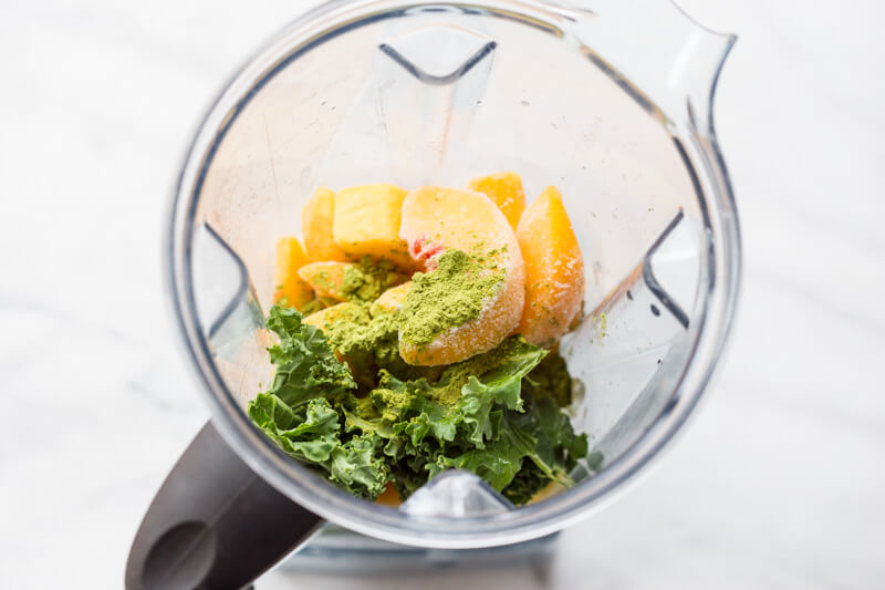 Go green with this mighty Matcha Green Tea Smoothie made with frozen mango, peaches, kale, orange juice, kefir, and matcha green tea powder. It's antioxidant rich, smooth and creamy and makes a great breakfast or snack!