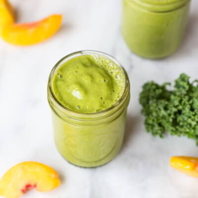 Go green with this mighty Matcha Green Tea Smoothie made with frozen mango, peaches, kale, orange juice, kefir, and matcha green tea powder. It's antioxidant rich, smooth and creamy and makes a great breakfast or snack!