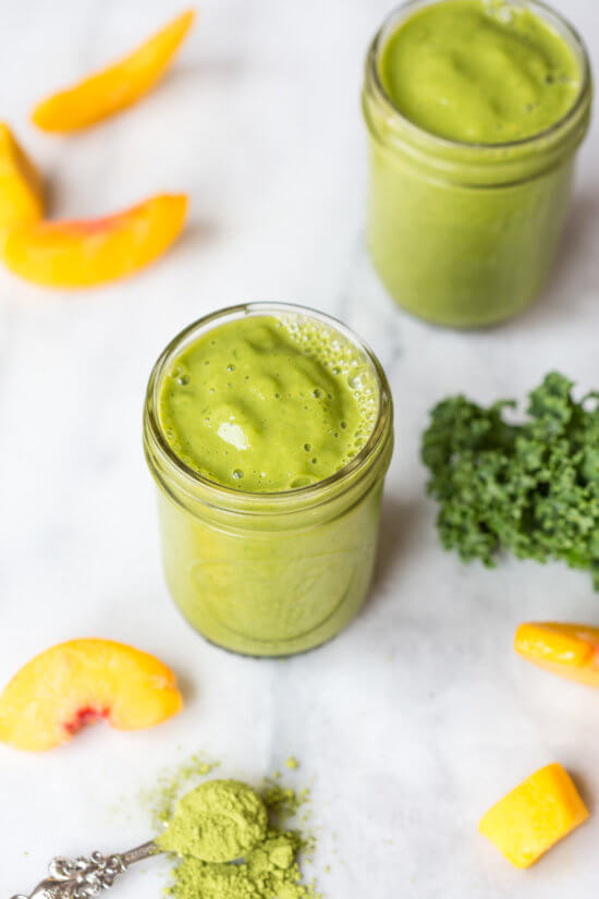 Go green with this mighty Matcha Green Tea Smoothie made with frozen mango, peaches, kale, orange juice, kefir, and matcha green tea powder. It's antioxidant rich, smooth and creamy and makes a great breakfast or snack!