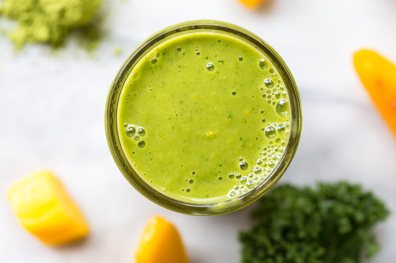 Go green with this mighty Matcha Green Tea Smoothie made with frozen mango, peaches, kale, orange juice, kefir, and matcha green tea powder. It's antioxidant rich, smooth and creamy and makes a great breakfast or snack!