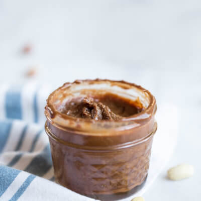 Homemade Chocolate Peanut Butter.... that's actually good for you and made with no added sugar. If you've ever wondered if you can make peanut butter at home, get excited because the answer is YES!! And chocolate is involved.