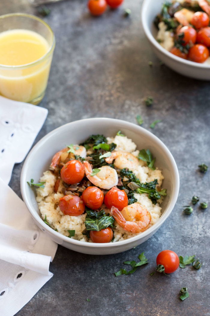 Shrimp and Cheesy Cauliflower Grits, a low carb southern breakfast. Cheesy cauliflower grits topped with savory shrimp, bacon, a hearty dose of kale, and blistered cherry tomatoes. 