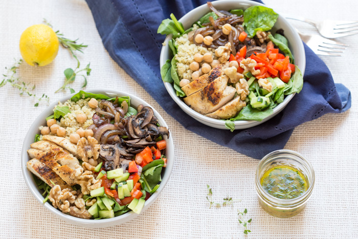 The perfect summer salad has grilled ingredients served warm served with fresh raw veggies. This Mediterranean Quinoa Chicken Salad bowl is topped with grilled chicken, sautéed onions and mushrooms and a zesty herb dressing.