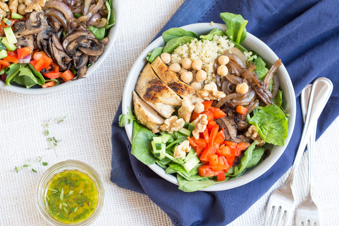 The perfect summer salad has grilled ingredients served warm served with fresh raw veggies. This Mediterranean Quinoa Chicken Salad bowl is topped with grilled chicken, sautéed onions and mushrooms and a zesty herb dressing.