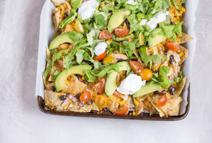 Love all the foods with tortilla chips and avocado... so naturally, Sheet Pan Chicken Nachos is a family favorite. It's one of those weeknight meals that we keep on rotation. 