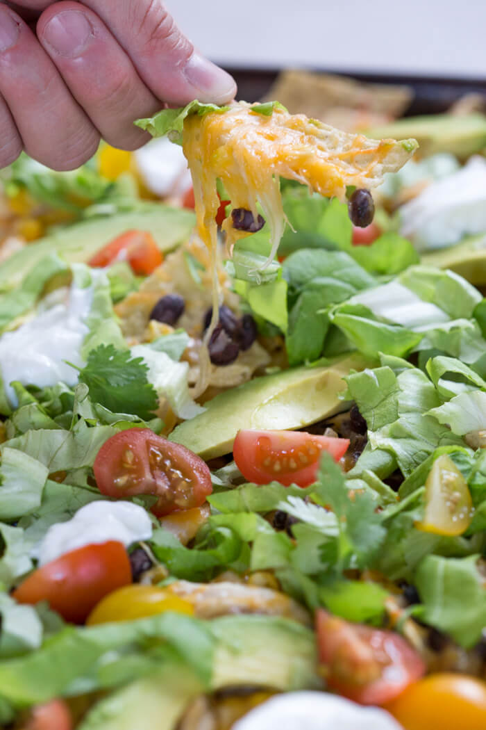 Love all the foods with tortilla chips and avocado... so naturally, Sheet Pan Chicken Nachos is a family favorite. It's one of those weeknight meals that we keep on rotation. 