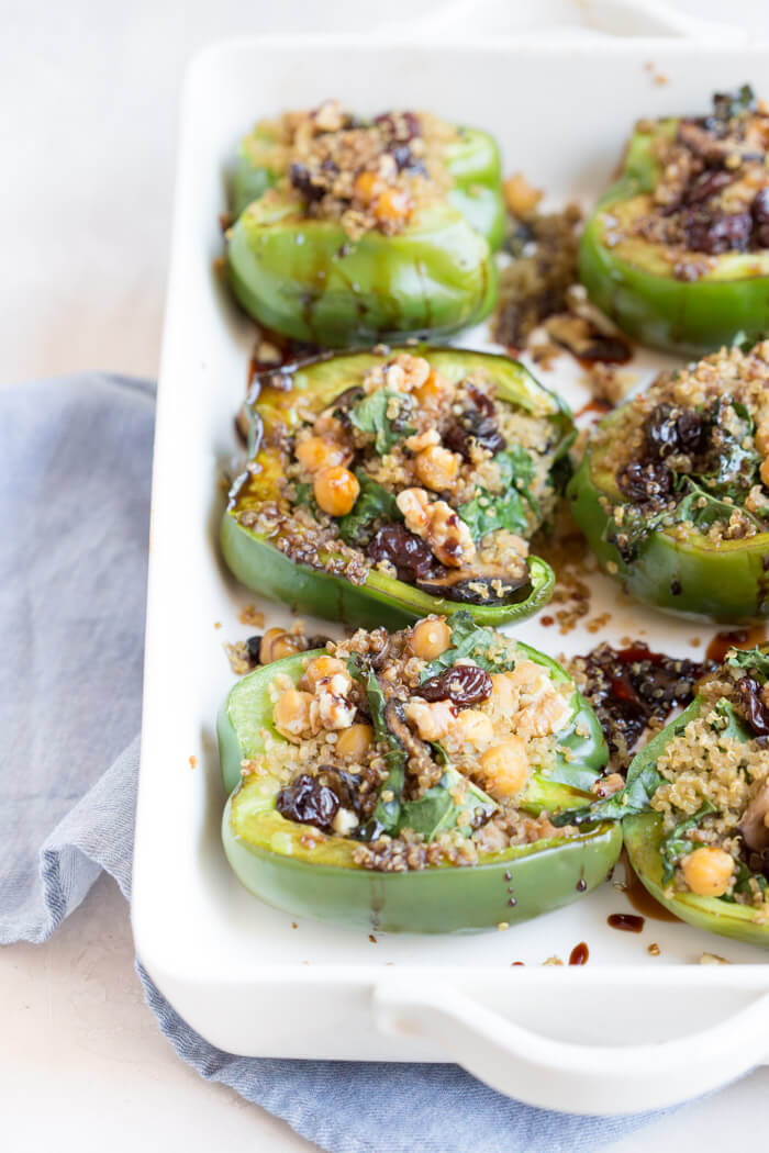 Vegetarian Quinoa Stuffed Peppers filled with quinoa, mushrooms, kale, dried tart cherries with walnuts and tart cherry reduction. A healthy veggie meal.