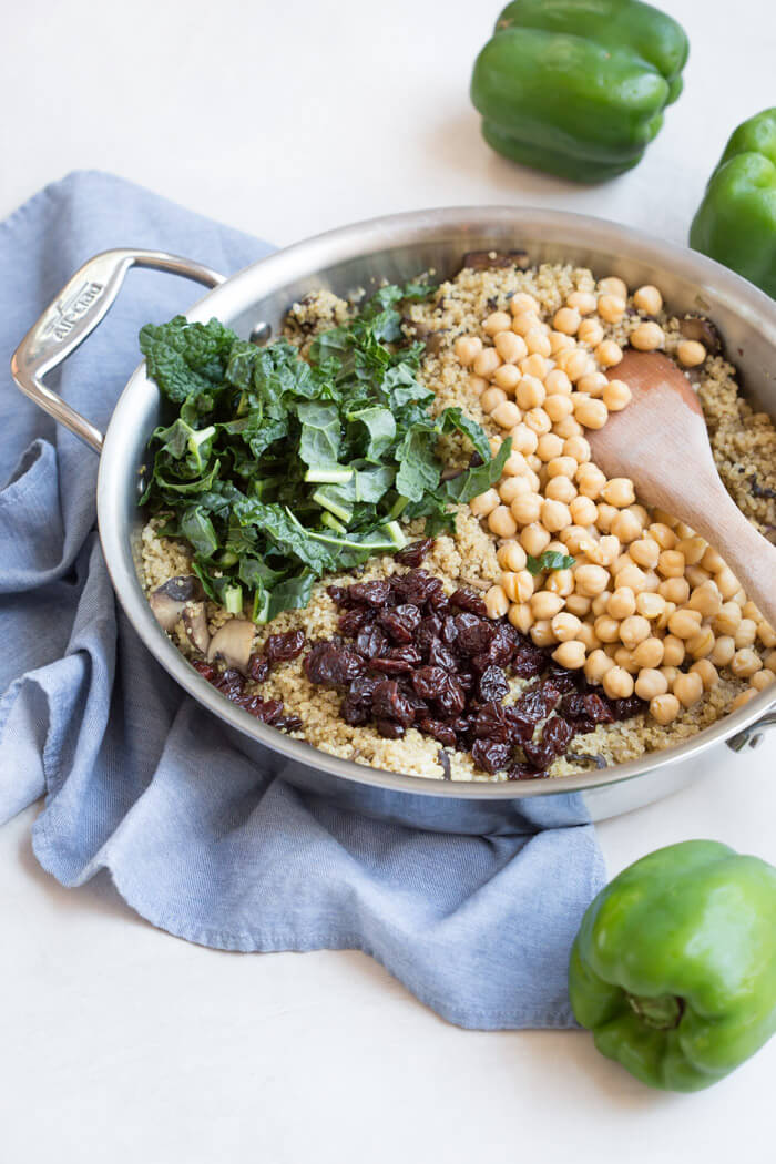 Vegetarian Quinoa Stuffed Peppers filled with quinoa, mushrooms, kale, dried tart cherries with walnuts and tart cherry reduction. A healthy veggie meal.