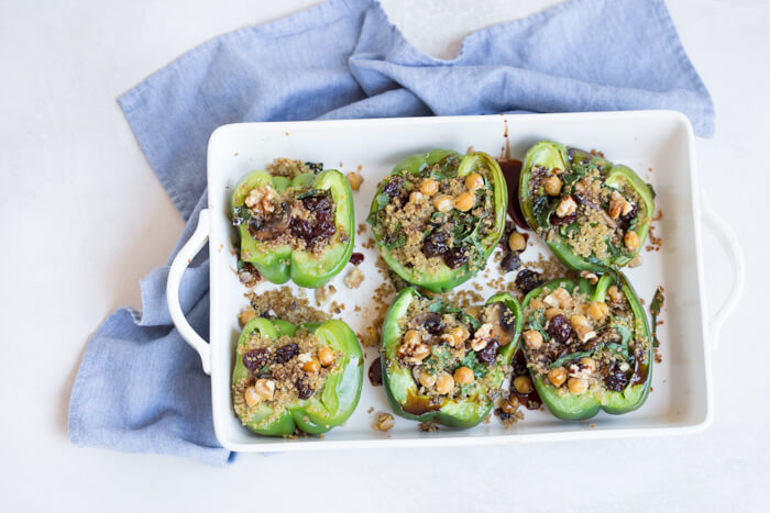 Vegetarian Quinoa Stuffed Peppers filled with quinoa, mushrooms, kale, dried tart cherries with walnuts and tart cherry reduction. A healthy veggie meal.