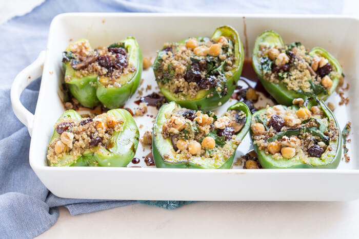 Vegetarian Quinoa Stuffed Peppers filled with quinoa, mushrooms, kale, dried tart cherries with walnuts and tart cherry reduction. A healthy veggie meal.