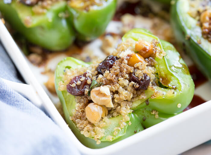 Vegetarian Quinoa Stuffed Peppers filled with quinoa, mushrooms, kale, dried tart cherries with walnuts and tart cherry reduction. A healthy veggie meal.