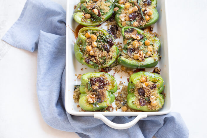 Vegetarian Quinoa Stuffed Peppers filled with quinoa, mushrooms, kale, dried tart cherries with walnuts and tart cherry reduction. A healthy veggie meal.