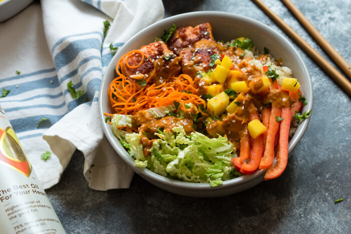 Spicy Thai Salmon Grain Bowls loaded with veggies, brown basmati rice and warm baked salmon and a drizzle of spicy Thai sauce.... because everything is better in bowl form.