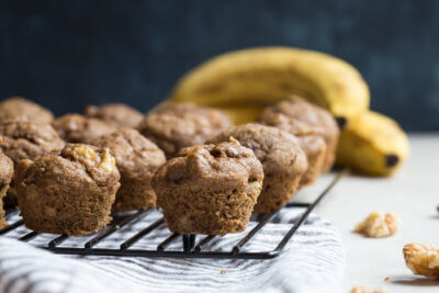 These Healthy Banana Bread Muffins with Walnuts are made with less sugar, whole wheat flour, and yes, that extra banana! We even subbed in maple syrup instead of white sugar into this recipe.