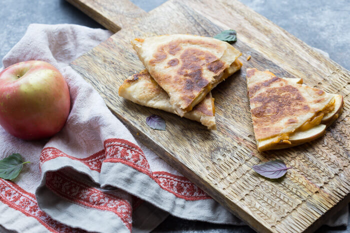 If you're looking for a simple comfort food dinner (or lunch) that tastes like fall-- this is it! Creamy Pumpkin Apple Quesadillas are perfect for little hands for snacking after school or before trick or treating. 