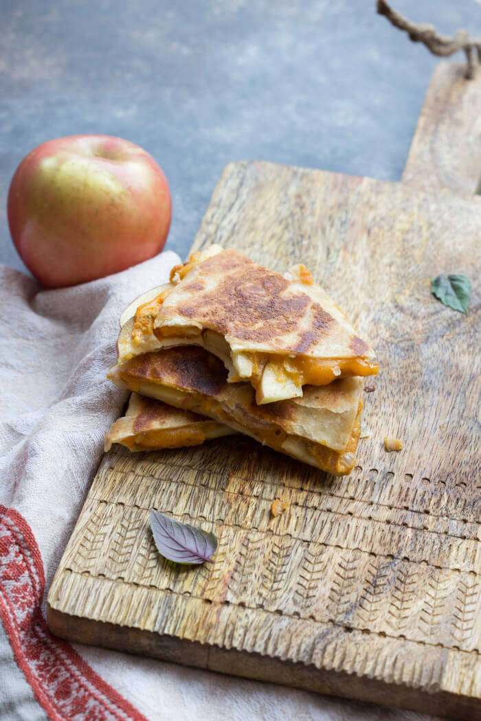 If you're looking for a simple comfort food dinner (or lunch) that tastes like fall-- this is it! Creamy Pumpkin Apple Quesadillas are perfect for little hands for snacking after school or before trick or treating. 