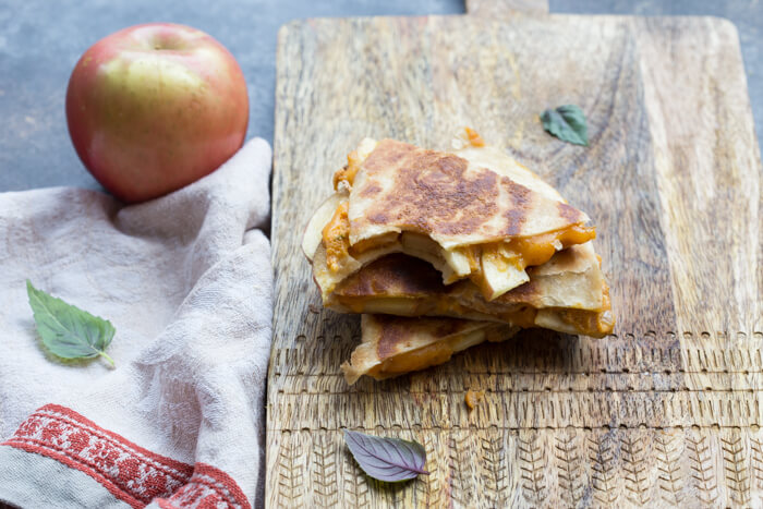 If you're looking for a simple comfort food dinner (or lunch) that tastes like fall-- this is it! Creamy Pumpkin Apple Quesadillas are perfect for little hands for snacking after school or before trick or treating. 