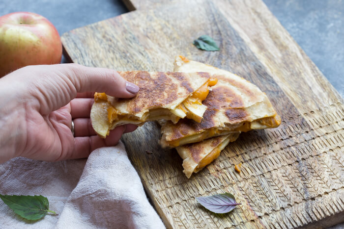 If you're looking for a simple comfort food dinner (or lunch) that tastes like fall-- this is it! Creamy Pumpkin Apple Quesadillas are perfect for little hands for snacking after school or before trick or treating. 