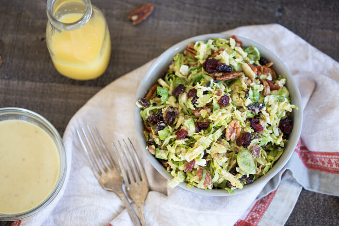 Shaved Brussels Sprout Salad with Citrus Bacon Vinaigrette... the best hearty and nourishing winter side salad to add to your holiday menu. 